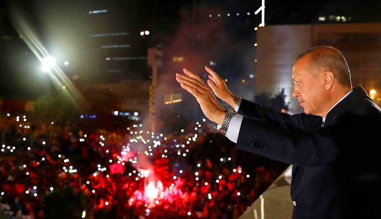 Turkey's President Recep Tayyip Erdogan, waves to supporters of his ruling Justice and Development Party in Ankara, Turkey, early Monday. Erdogan won Turkey's landmark election Sunday, the country's electoral commission said, ushering in a new system granting the president sweeping new powers which critics say will cement what they call a one-man rule.