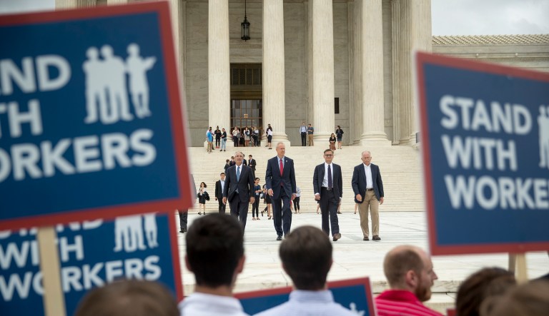 Plaintiff Mark Janus walk out of the the Supreme Court after the court rules in a setback for organized labor that states can't force government workers to pay union fees in Washington, June 27, 2018.