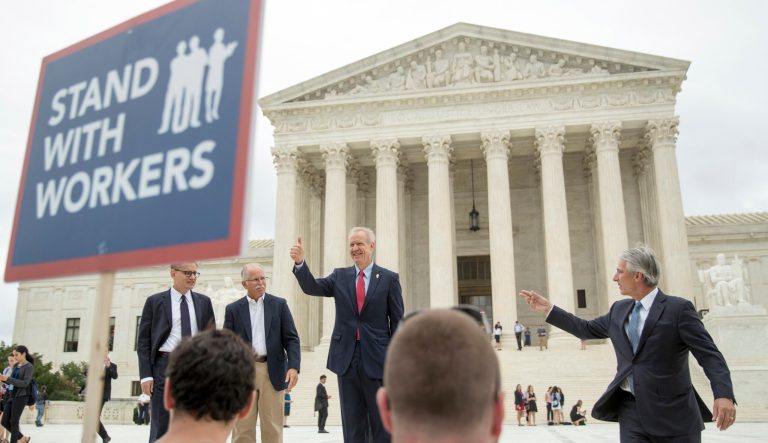 Illinois Gov. Bruce Rauner gives a thumbs up outside the Supreme Court, Wednesday, June 27, 2018 in Washington.
