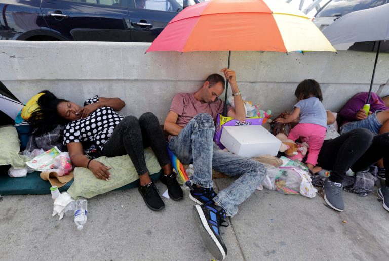 Immigrants from Guatemala and Cuba seeking asylum in the United States wait on the Matamoros International Bridge, Thursday, June 28, 2018, in Matamoros, Mexico.