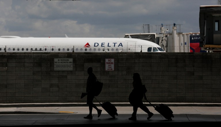 Travelers walk to their terminal at the Fort LauderdaleâHollywood International Airport in Fort Lauderdale, Fla. Esteban Santiago-Ruiz, who was responsible for a shooting there in 2017, has been sentenced to five life terms in prison.