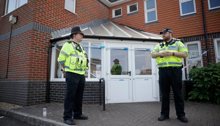 British police officers guards a cordon outside the Amesbury Baptist Centre church in Amesbury, England, Wednesday, July 4, 2018. British police have declared a "major incident" after two people were exposed to an unknown substance in the town, and are cordoning off places the people are known to have visited before falling ill.