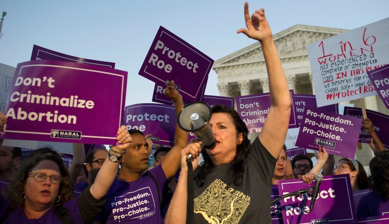 Demonstrators yell in front of the Supreme Court in Washington, Monday, July 9, 2018, as President Donald Trump announced Judge Brett Kavanaugh as his Supreme Court nominee.
