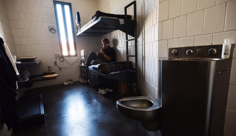 Inmate Adam Anderson sits in his cell playing the guitar while waiting for an inmate count Wednesday, June 27, 2018, at the Eastern Oregon Correctional Institute in Pendleton, Oregon. Anderson is serving a 25-year sentence for assault, robbery and kidnapping and will not be released until 2021.