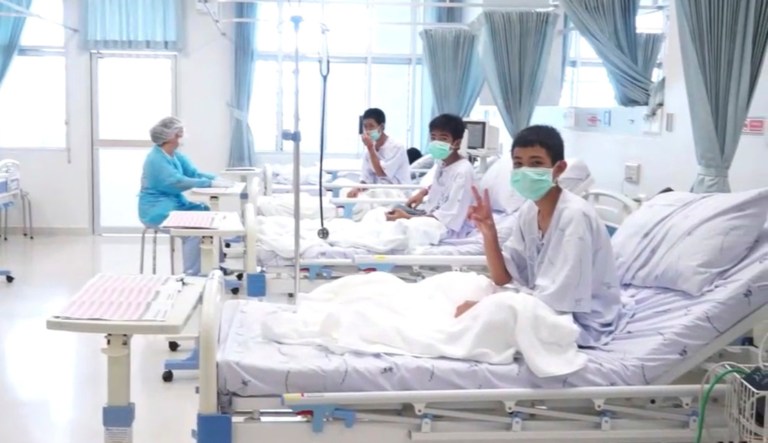 In this image made from video, released by the Thailand Government Spokesman Bureau, three of the 12 boys are seen recovering in their hospital beds after being rescued along with their coach from a flooded cave in Mae Sai, Chiang Rai province, northern Thailand.