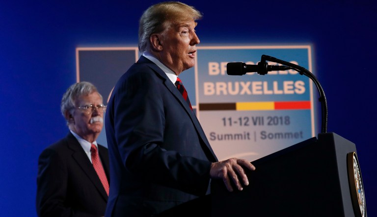 U.S. President Donald Trump speaks during a news conference before departing the NATO Summit in Brussels, Belgium, Thursday, July 12, 2018. On stage with Trump is National Security Adviser John Bolton.