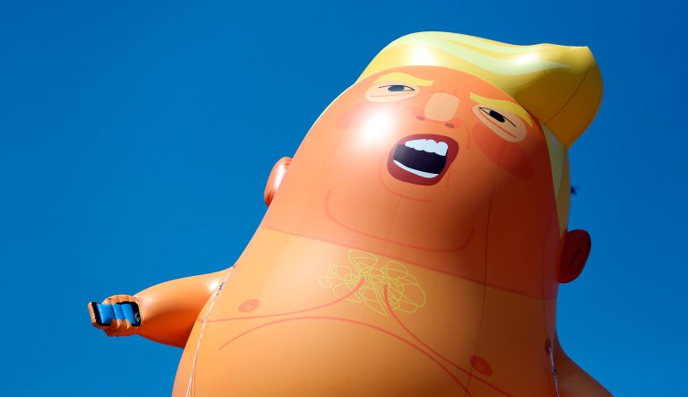 A six-meter high cartoon baby blimp of President Trump is flown as a protest against his visit, in Parliament Square in London, England, Friday, July 13, 2018.