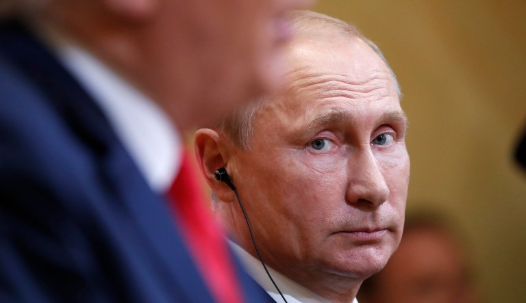 Russian President Vladimir Putin listens to President Trump during a press conference after their meeting in Helsinki on July 16, 2018.