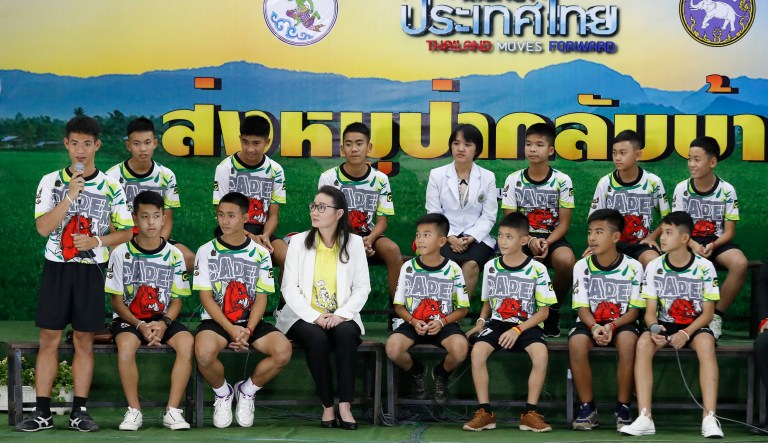 Coach" Ake" Ekkapol Janthawong, left, speaks on behalf of the 12 boys and himself and their cave rescue during a press conference discussing their ordeal in Chiang Rai, northern Thailand, Wednesday, July 18, 2018. The 12 boys and their soccer coach rescued after being trapped in a flooded cave in northern Thailand are recovering well and are eager to eat their favorite comfort foods after their expected discharge from a hospital soon. 