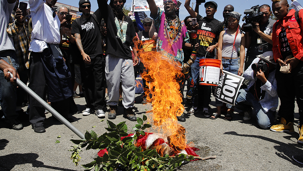 Maxine Waters backers burn stolen American flag