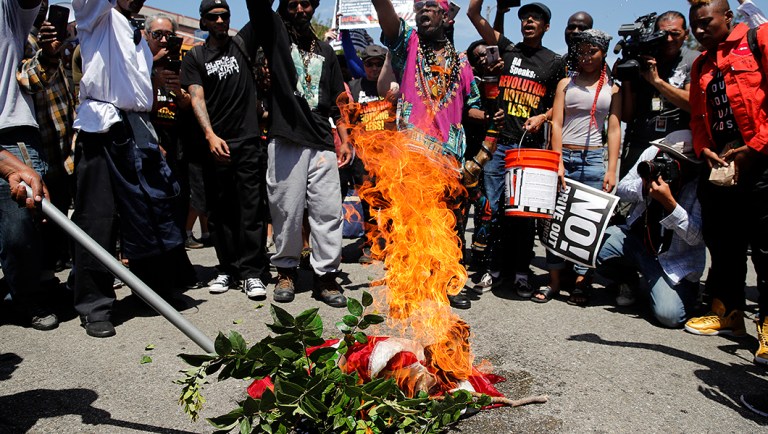 Maxine Waters backers burn stolen American flag