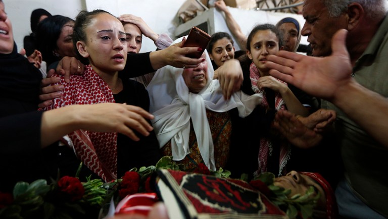 Palestinian mourn over the body of Arkan Mezeher, 15, during his funeral in Deheisha refugee camp, near the West Bank city of Bethlehem, Monday, July 23, 2018. Mezher was fatally shot in the chest when clashes erupted during an Israeli military arrest raid on the camp. (AP Photo/Majdi Mohammed)