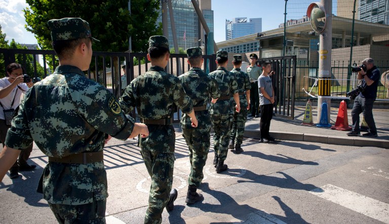 Chinese paramilitary police march in formation toward the U.S. Embassy in Beijing. A man exploded a small homemade bomb outside the U.S. Embassy in Beijing, injuring only himself, according to police and an embassy spokesperson. 
