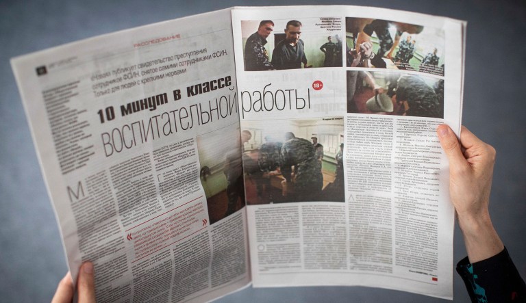 This photo taken on Thursday, July 26, 2018, shows a double page of the Russian Independent newspaper Novaya Gazeta with the story about beatings in Yaroslavl's prison, in Moscow, Russia.  A video obtained by Lawyer Irina Biryuokova, showing a prisoner being beaten while handcuffed, has caused wide concern after publication by the newspaper Novaya Gazeta.