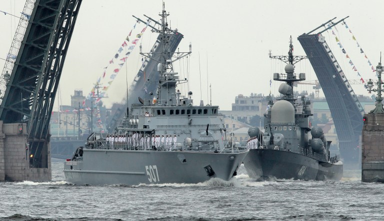 Warships float past the Dvortsovy (Palace) and Troitsky (Trinity) drawbridges rising above the Neva River during a Naval parade rehearsal in St.Petersburg, Russia, Thursday, July 26, 2018. The celebration of Navy Day in Russia is traditionally marked on the last Sunday of July and will be celebrated on July 29 this year.
