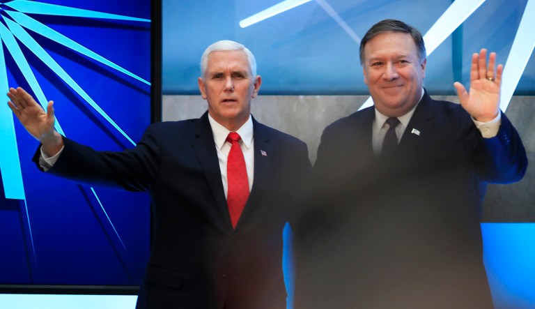 Vice President Mike Pence and Secretary of State Mike Pompeo, right, wave following a speech by Pence at the close of a three-day conference on religious freedom at the State Department in Washington, Thursday, July 26, 2018, as the Trump administration comes under criticism for strict refugee and migration policies that have sharply reduced America's intake of people fleeing persecution over their beliefs. 