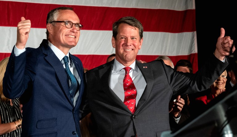 Georgia Republican Lt. Gov. Casey Cagle, left, and Secretary of State Brian Kemp celebrate during a unity rally on Thursday in Peachtree Corners, Ga. The pair faced off in a heated gubernatorial runoff race which Kemp won.