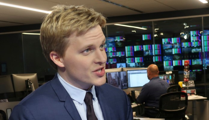Ronan Farrow, a contributing writer for the New Yorker, speaks with reporters.