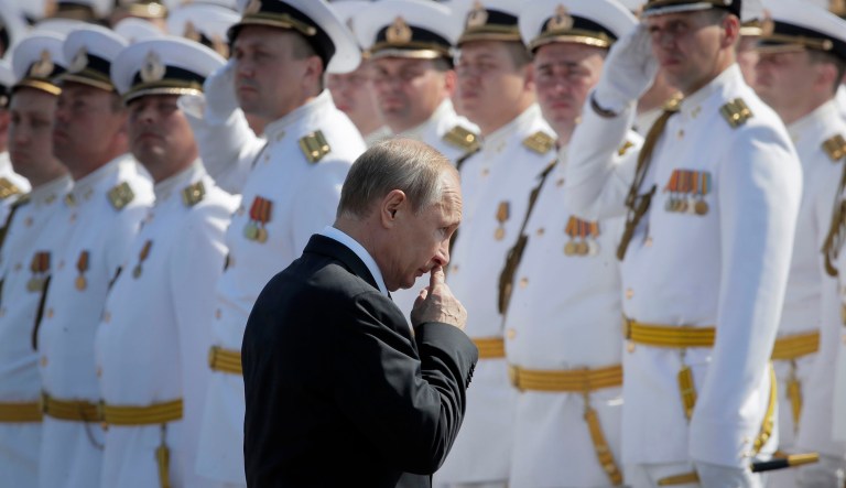 Russian President Vladimir Putin walks to attend the military parade during the Navy Day celebration in St.Petersburg, Russia, Sunday, July 29, 2018.