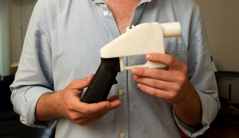 Cody Wilson, the founder of Defense Distributed, shows a plastic handgun made on a 3D-printer at his home in Austin, Texas.