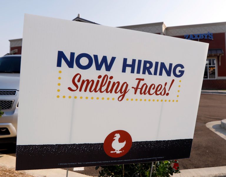 This is a July 25, 2018 photograph of a help wanted sign at a new Zaxby's restaurant in Madison, Miss. A new survey shows workers are generally happy and optimistic and feel getting another job would be easy.