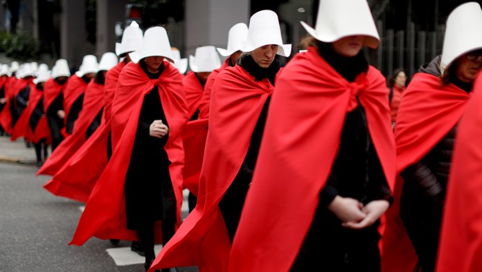 Women in favor of a measure to expand legal abortions, wearing red cloaks and white bonnets like the characters from the novel-turned-TV series "The Handmaid's Tale."