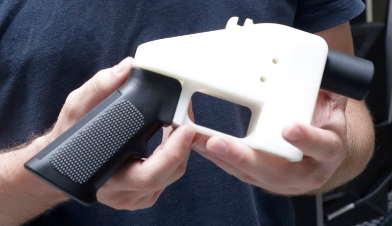 Cody Wilson, with Defense Distributed, holds a 3D-printed gun called the Liberator at his shop, Wednesday, Aug. 1, 2018, in Austin, Texas. A federal judge in Seattle  issued a temporary restraining order Tuesday to stop the release of blueprints to make untraceable and undetectable 3D-printed plastic guns.
