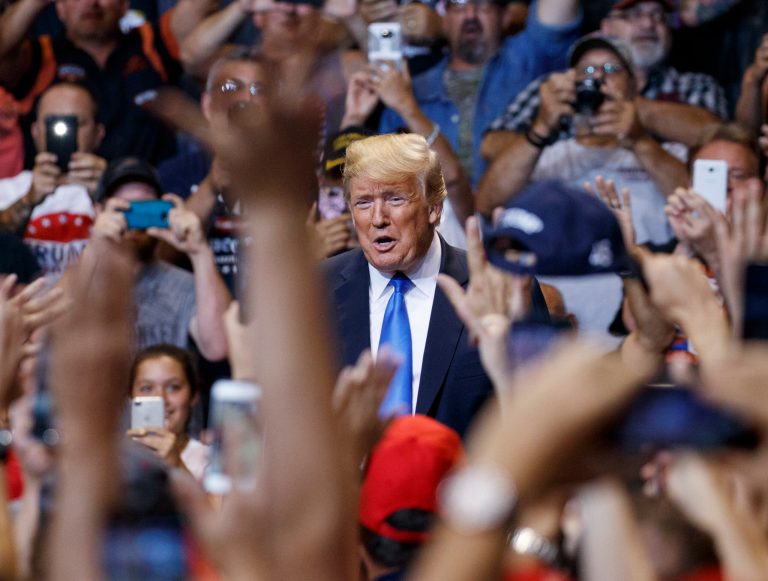 IN this Aug. 2, 2018, photo, President Donald Trump is cheered as he arrives for a rally at Mohegan Sun Arena at Casey Plaza in Wilkes Barre, Pa.