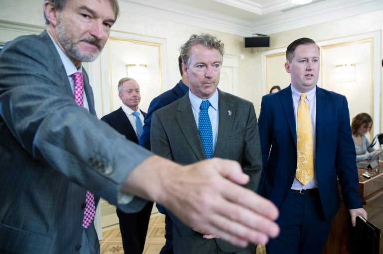 Sen. Rand Paul, center, and his Deputy Chief of Staff Sergio Gor, right, enter a hall during their meeting with Russian lawmakers in Moscow, Russia, Monday, Aug. 6, 2018. Paul said he invited Russian lawmakers to visit the United States to help foster inter-parliamentary contacts.