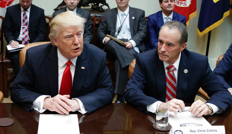  U.S. Rep. Chris Collins, right, of New York, sits next to President Donald Trump.