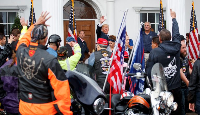 President Trump waves as he is cheered by members of Bikers for Trump and supporters, Saturday, Aug. 11, 2018, at the clubhouse of Trump National Golf Club in Bedminster, N.J. 