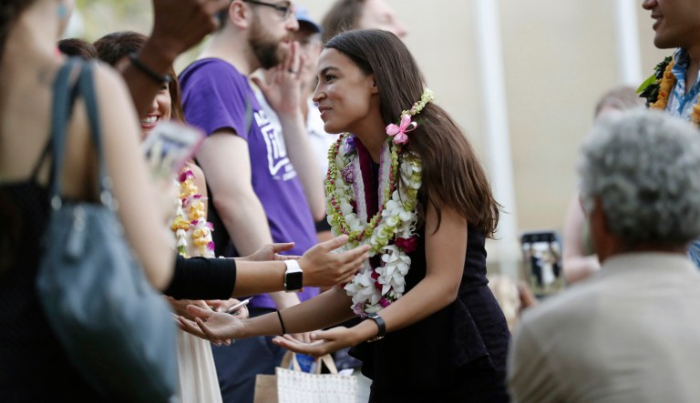 In this Thursday, Aug. 9, 2018 photo, Alexandria Ocasio-Cortez, a Democratic congressional candidate from New York, makes an appearance to support Hawaii Congressional candidate Kaniela Ing at a campaign rally held at the Hawaii School for the Deaf and Blind in Waikiki, Hawaii. Ing, a state representative,  is hoping his calls for tuition free college, cancelling student debt and Medicare-for-all will help him reprise the dramatic come-from-behind victory his New York democratic socialist colleague, Ocasio-Cortez, scored two months ago.
