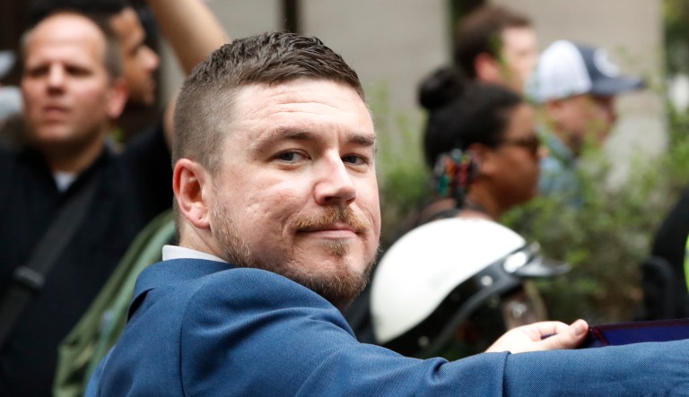 White nationalist Jason Kessler walks to the White House to rally on the one year anniversary of the Charlottesville "Unite the Right" rally on Sunday in D.C.
