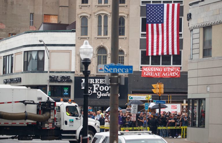 A crowd gathers in Utica, N.Y., Monday, Aug. 13, 2018, where President Donald Trump is to speak at a fundraising committee reception in Utica, N.Y.
