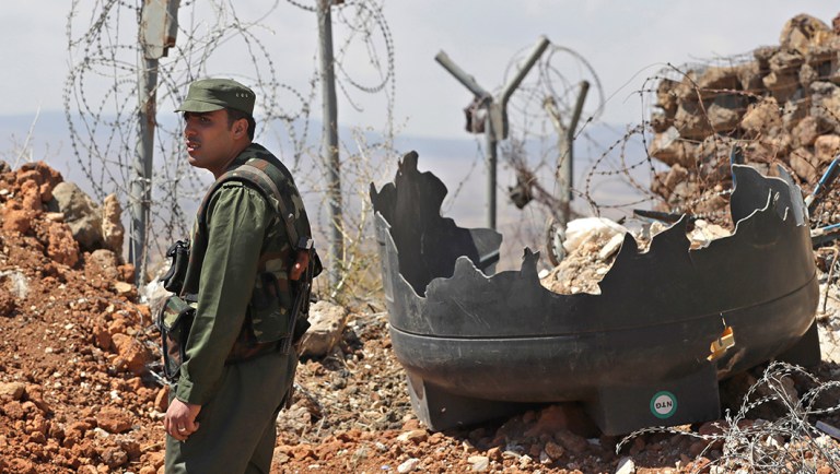 Syrian army soldier stands guard at post near village of Tal Kroum, Syria.
