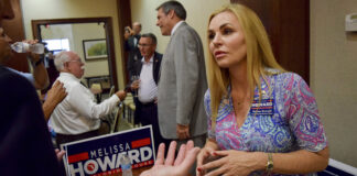 In this Tuesday, July 17, 2018 photo, Melissa Howard who is running for the District 73 State House seat being vacated by state Rep. Joe Gruters meets with voters during a "meet the candidates" event at Gold Coast Eagle Distriburing in Lakewood Ranch, Fla. Howard, a Republican candidate for the Florida Legislature who falsely claimed she had a college degree and posted a purported copy of her diploma online dropped out of her race on Tuesday, Aug. 14, 2018.  