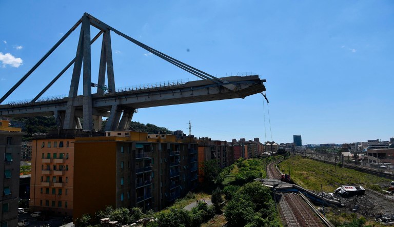 A view of the evacuated houses built under the remains part of the collapsed Morandi highway bridge, in Genoa, northern Italy, Wednesday, Aug. 15, 2018. A bridge on a main highway linking Italy with France collapsed in the Italian port city of Genoa during a sudden, violent storm, sending vehicles plunging 90 meters (nearly 300 feet) into a heap of rubble below. 