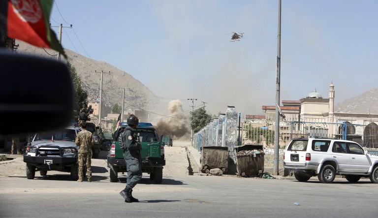 A military helicopter and security personnel are seen in Kabul, Afghanistan.