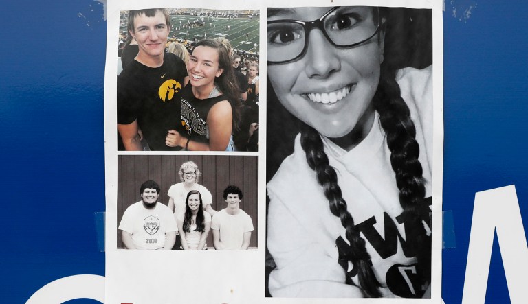 A poster for missing University of Iowa student Mollie Tibbetts hangs on the front door of a local business in Iowa.