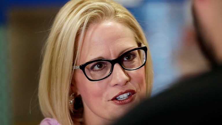 Senatorial candidate Rep. Kyrsten Sinema, D-Ariz., speaks with volunteers in Phoenix.
