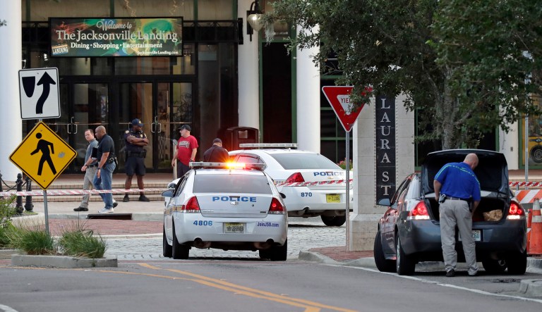 Police cars block off a street near the scene of a mass shooting as law enforcement investigators work on the area at Jacksonville Landing in Jacksonville, Fla., Sunday, Aug. 26, 2018. Florida authorities are reporting multiple fatalities at the riverfront mall that was hosting a video game tournament. Sunday, Aug. 26, 2018, in Jacksonville, Fla.