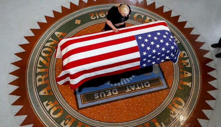 Meghan McCain, daughter of, Sen. John McCain, R-Ariz., touches the casket during a memorial service at the Arizona Capitol on Wednesday, Aug. 29, 2018, in Phoenix.