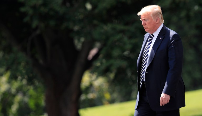 President Trump walks on the South Lawn as he leaves the White House. 