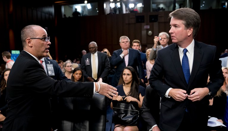 Fred Guttenberg, the father of Jamie Guttenberg who was killed in the Stoneman Douglas High School shooting in Parkland, Fla., left, attempts to shake hands with President Trump's Supreme Court nominee, Brett Kavanaugh, right, as he leaves for a lunch break while appearing before the Senate Judiciary Committee on Capitol Hill in Washington on Tuesday to begin his confirmation to replace retired Justice Anthony Kennedy. Kavanaugh did not shake his hand. 