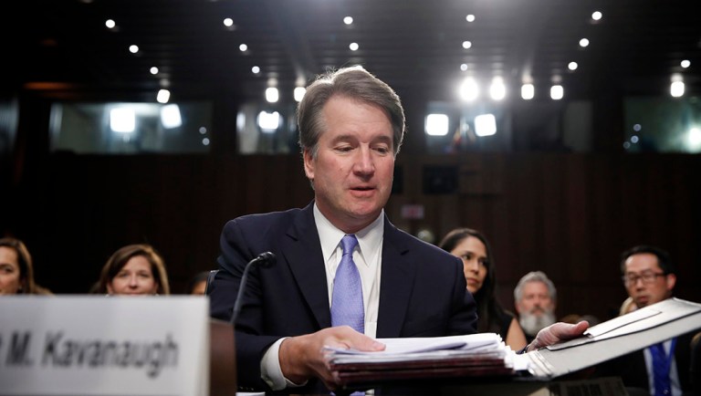President Trump's Supreme Court nominee, Brett Kavanaugh readies his papers before he testifies before the Senate Judiciary Committee.