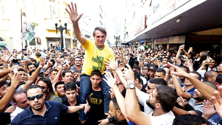 Presidential candidate Jair Bolsonaro is taken on the shoulders of a supporter moments before being stabbed.