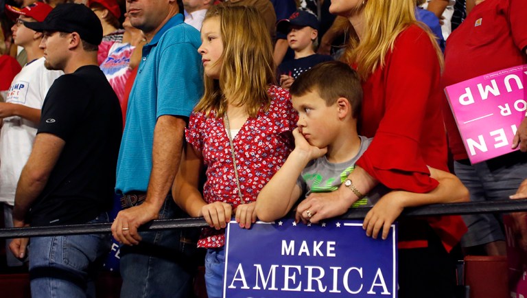 Supporters of President Trump wait for him to speak at rally.