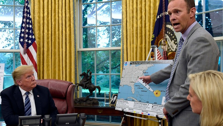 President Donald Trump, left, listens as FEMA Administrator Brock Long, center, talks about Hurricane Florence in the Oval Office of the White House in Washington, Tuesday, Sept. 11, 2018, as Homeland Security Secretary Kirstjen Nielsen listens at right.