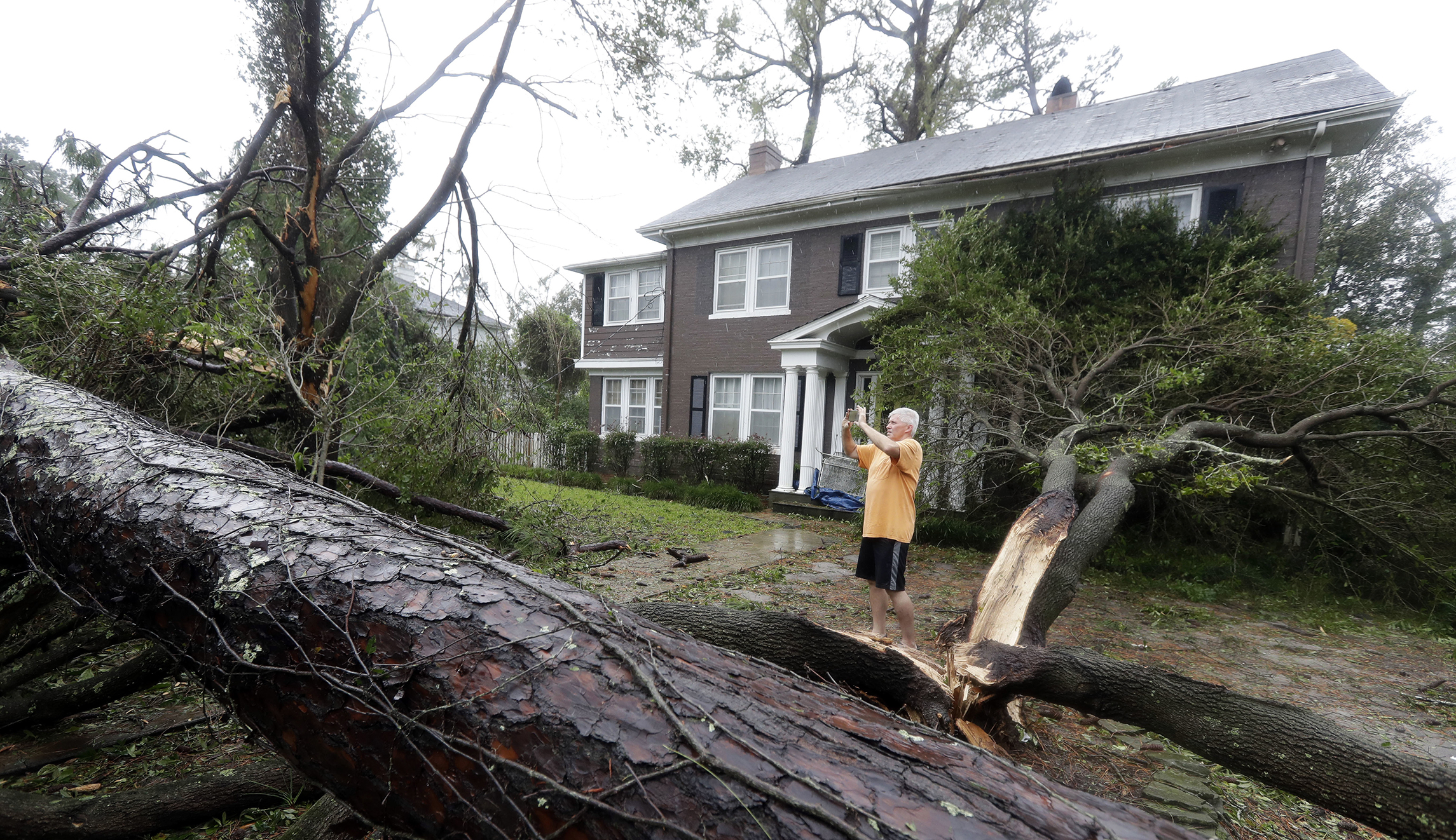 Mike Kiernan takes photos of the damage to his home in Wilmington, N.C., after Hurricane Florence made landfall Friday.