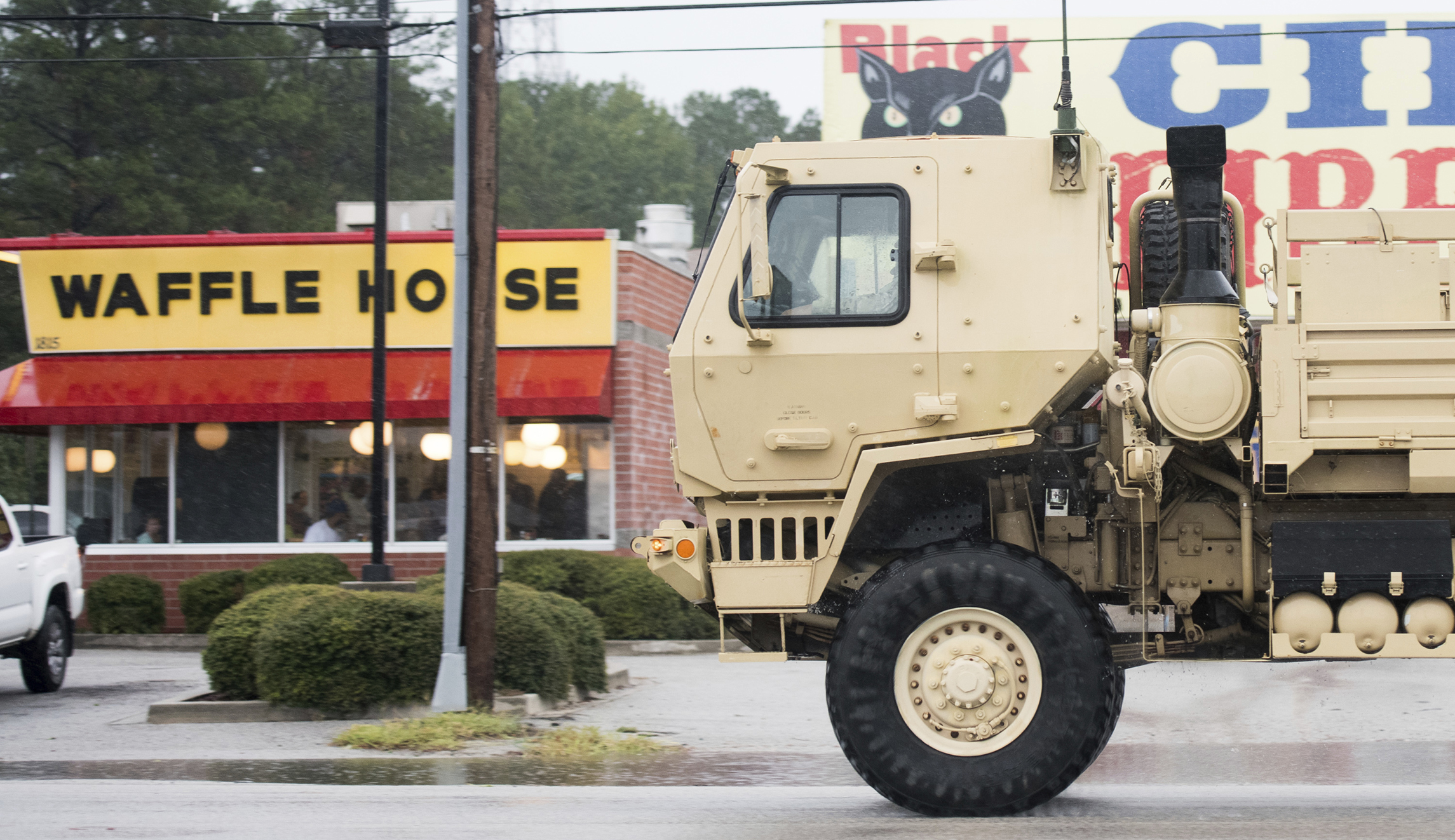 A National Guard vehicle drives past a Waffle House as Hurricane Florence slowly moves across the East Coast Friday, Sept. 14, 2018, in Florence, S.C.